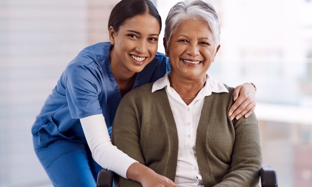 portrait, healthcare or disability with a nurse and old woman in a wheelchair during a nursing home visit. smile, medical or retirement with a happy female medicine professional and senior client